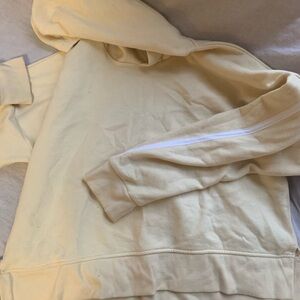 New cropped hoodie, very soft. White stripe detail on a pale yellow color.